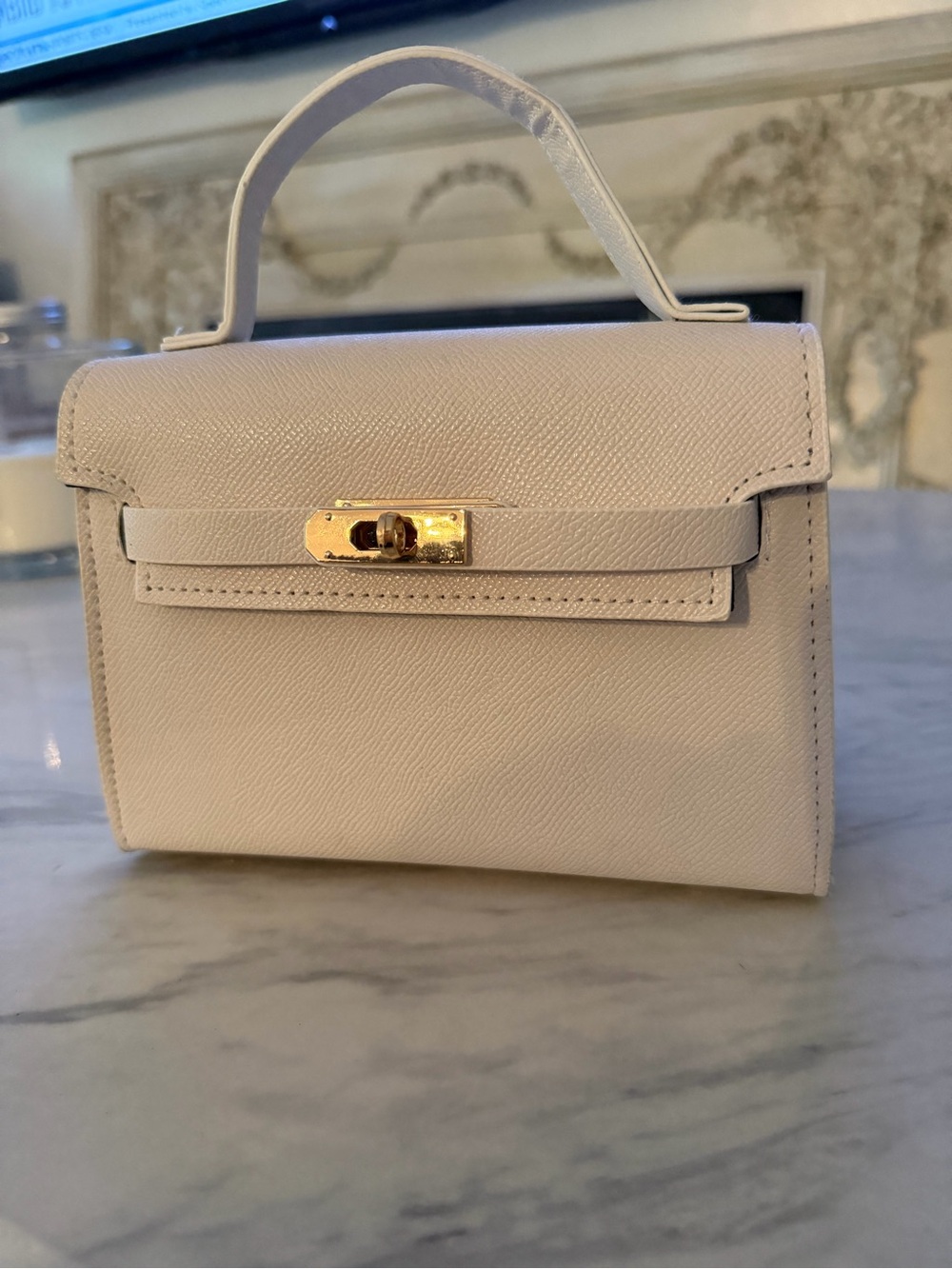 Elegant Cream Top-Handle Mini Bag with Gold Hardware